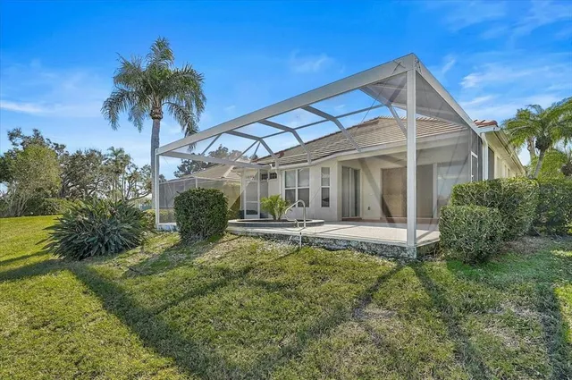 a view of a house with a yard and potted plants