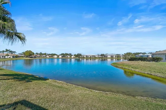 a view of a lake with houses in the background