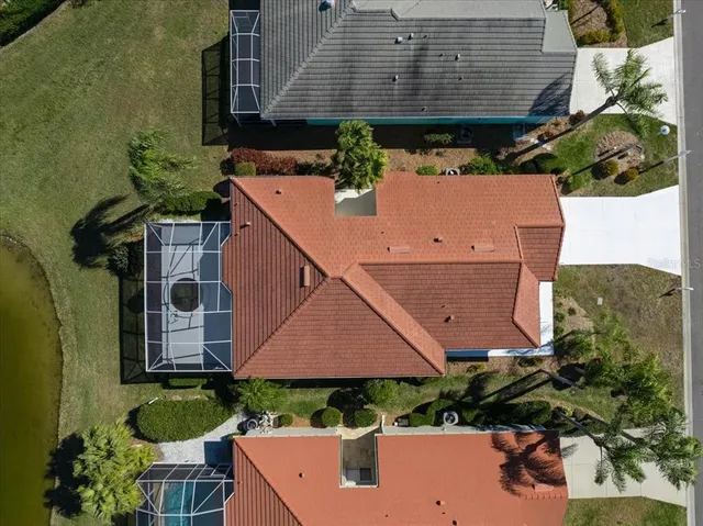 an aerial view of a house with garden space and street view