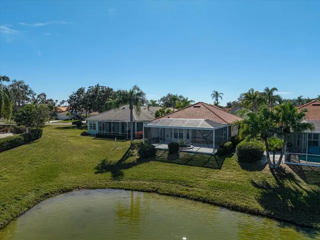 a view of a house with swimming pool and a yard