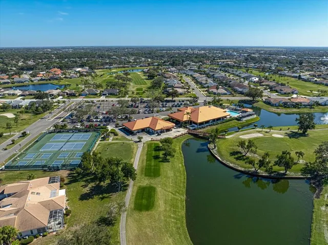 an aerial view of residential houses with outdoor space and lake view