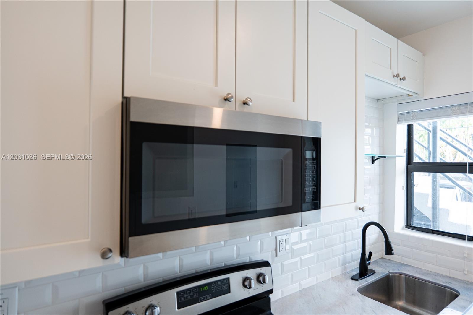 1721 Southwest 13th Street, Unit 4 Miami, FL 33145 - Photo 6 of 24 a bathroom with mirror and window