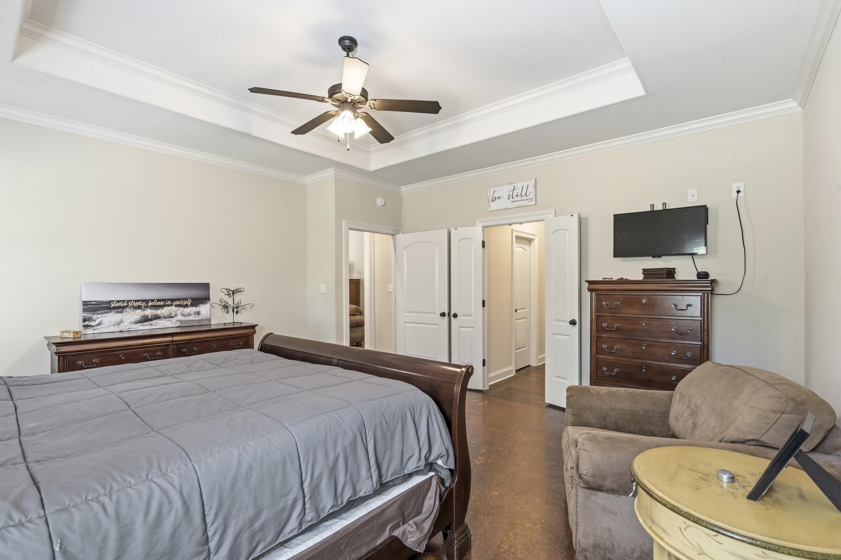 1795 Gaines Road Hernando, MS 38632 - Photo 13 of 40 a bedroom with a bed a couch and a flat screen tv