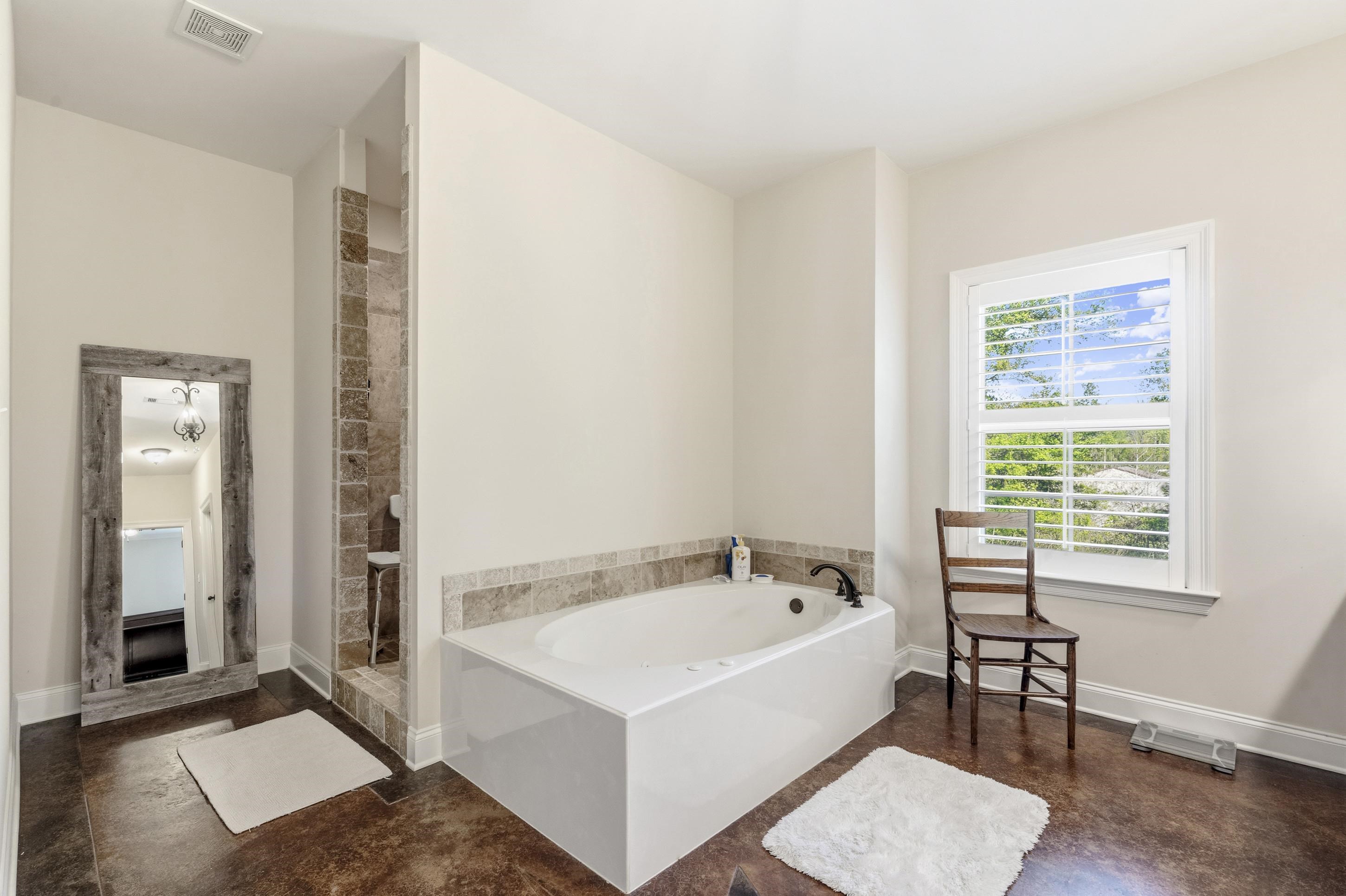 1795 Gaines Road Hernando, MS 38632 - Photo 16 of 40 a white bath tub sitting in a bathroom next to a window