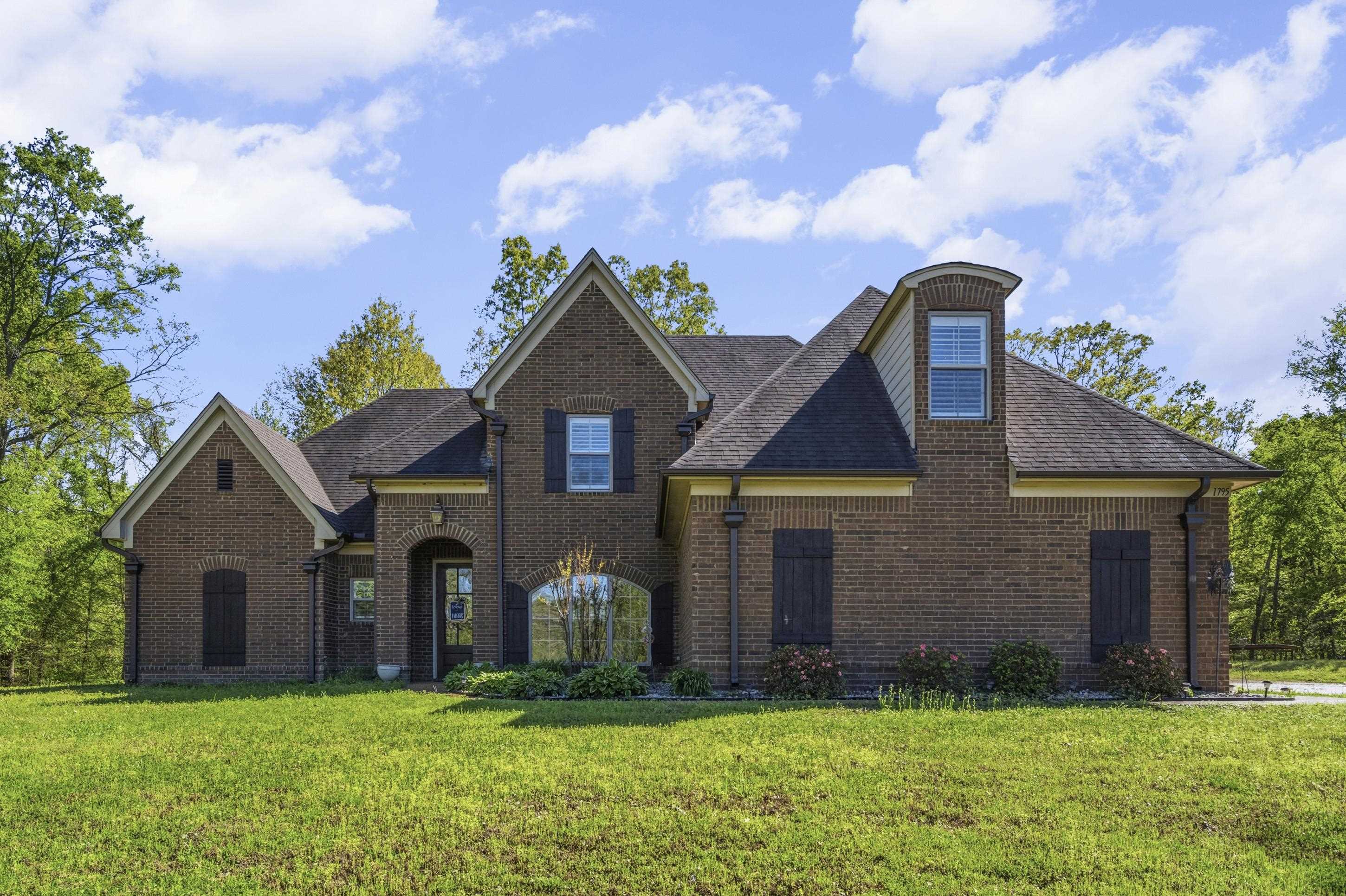 1795 Gaines Road Hernando, MS 38632 - Photo 2 of 40 a front view of a house with a yard
