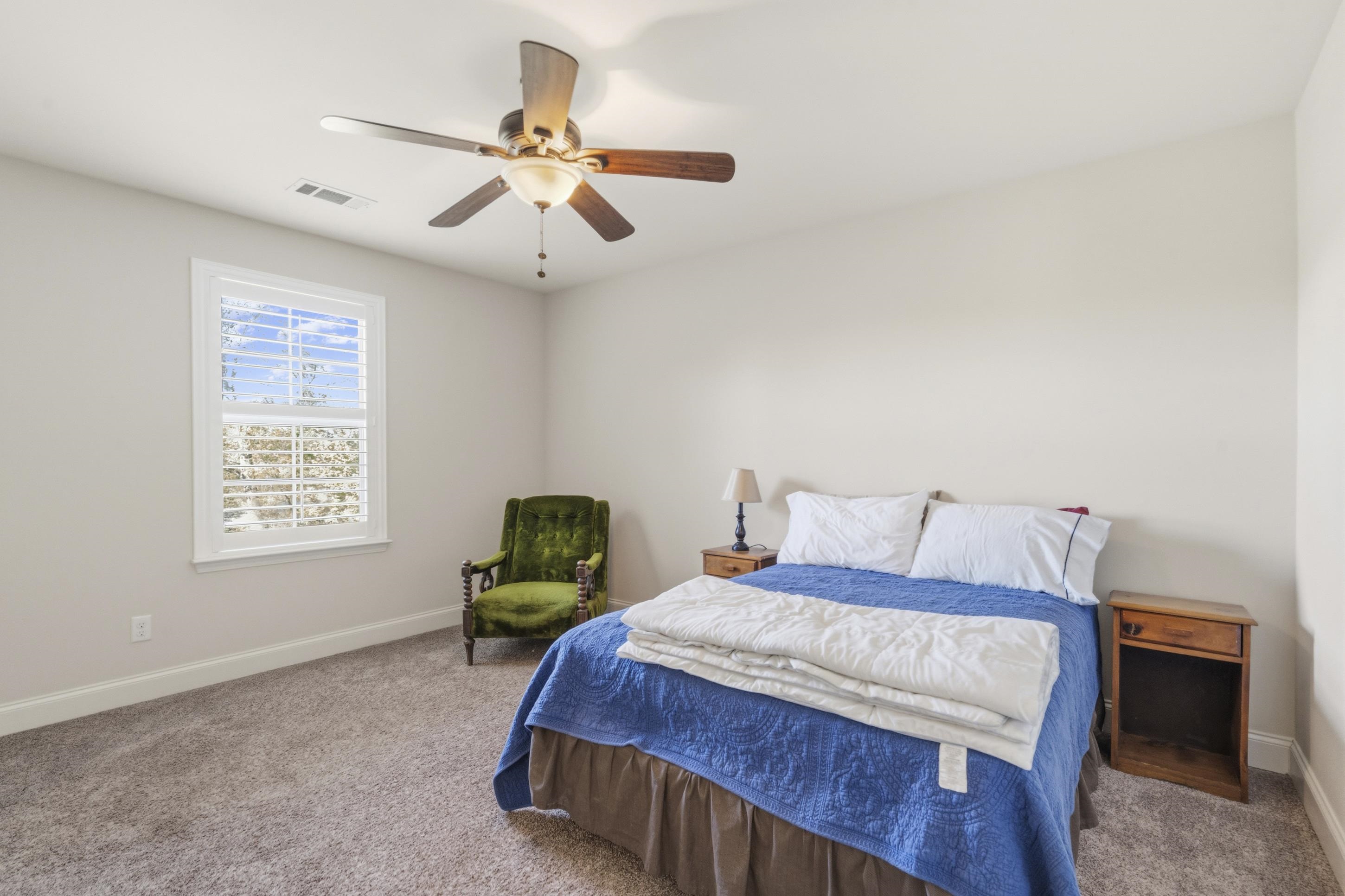 1795 Gaines Road Hernando, MS 38632 - Photo 21 of 40 a bedroom with a bed and a chandelier