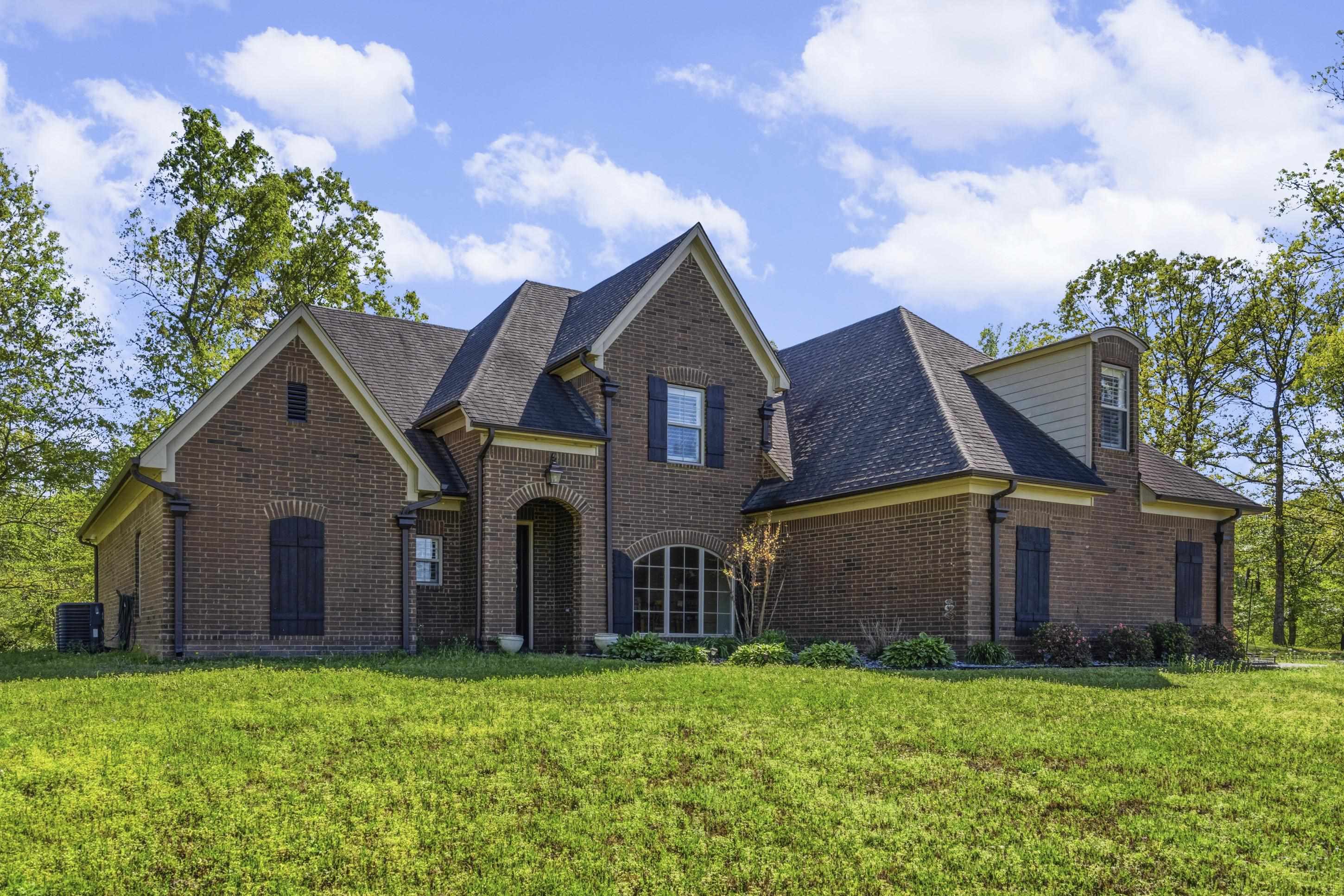 1795 Gaines Road Hernando, MS 38632 - Photo 3 of 40 a view of a big house with a big yard and large trees
