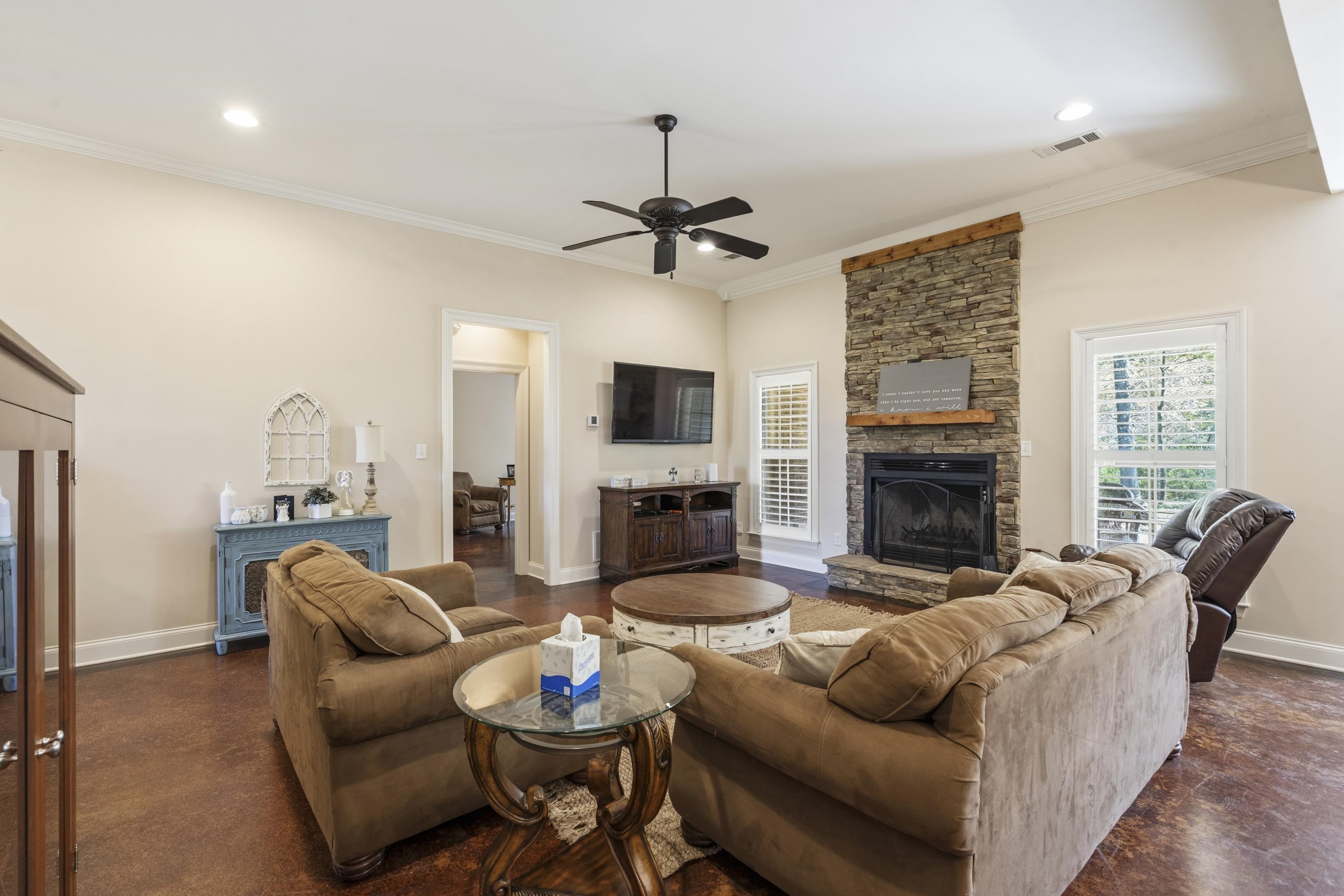 1795 Gaines Road Hernando, MS 38632 - Photo 7 of 40 a living room with furniture a fireplace and a flat screen tv