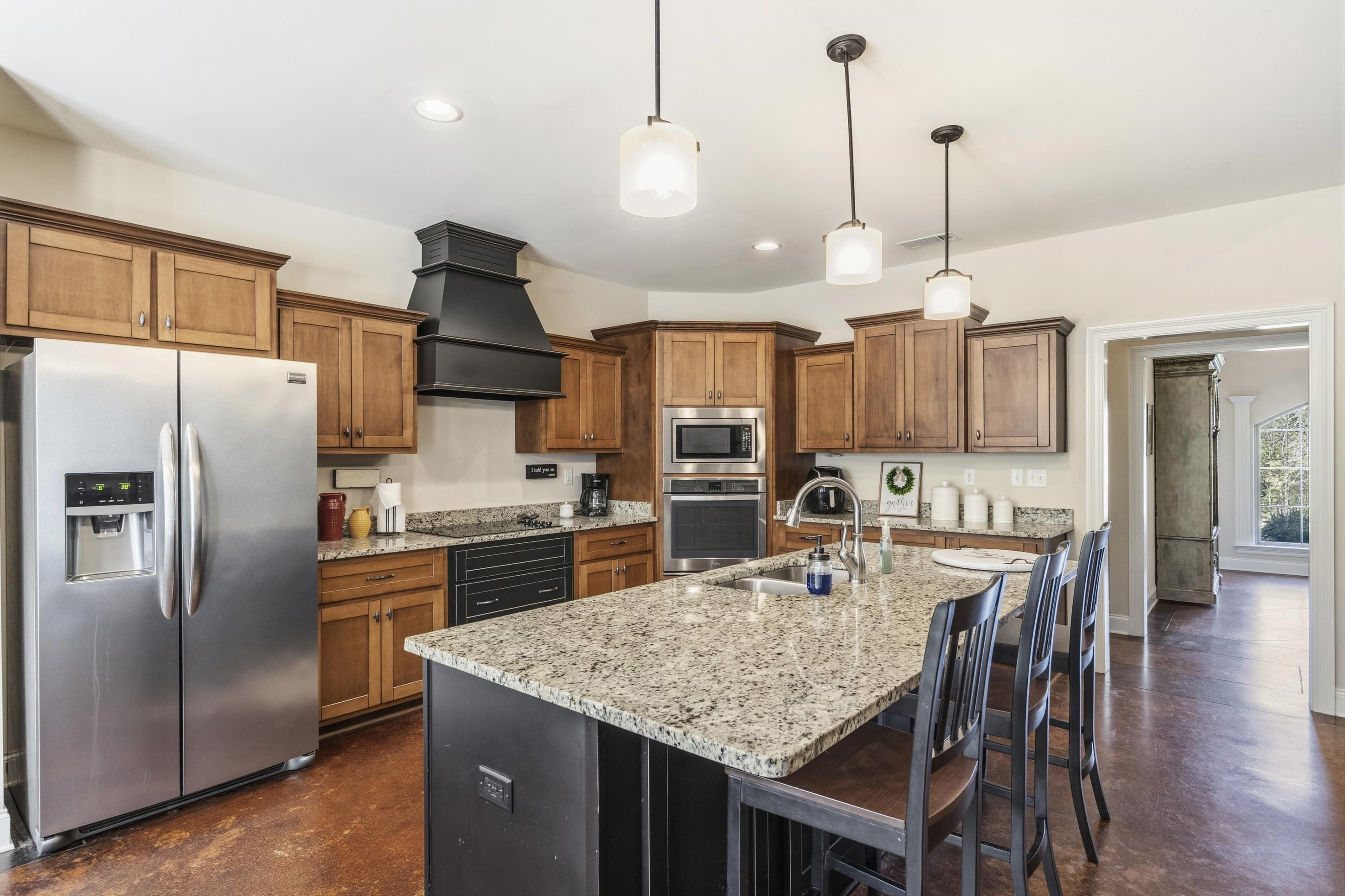 1795 Gaines Road Hernando, MS 38632 - Photo 10 of 40 a kitchen with stainless steel appliances granite countertop a kitchen island a stove a table and chairs