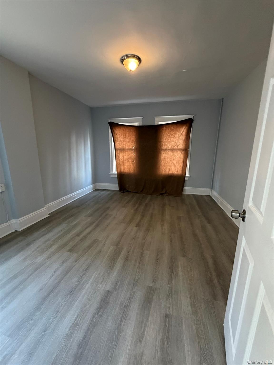 4 Ritters Lane, Unit 1 Yonkers, NY 10703 - Photo 2 of 22 an empty room with wooden floor and windows
