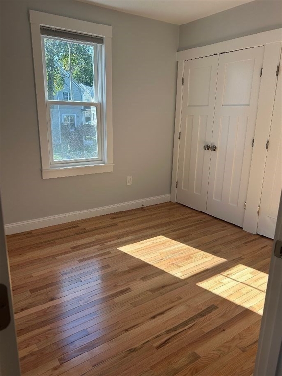 29 Orange Street, Unit B Boston, MA 02131 - Photo 11 of 23 a view of an empty room with wooden floor and a window