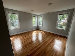 29 Orange Street, Unit B Boston, MA 02131 - Photo 13 of 23 a view of an empty room with wooden floor and a window
