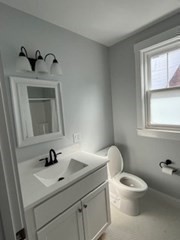29 Orange Street, Unit B Boston, MA 02131 - Photo 15 of 23 a bathroom with a toilet sink a window and mirror