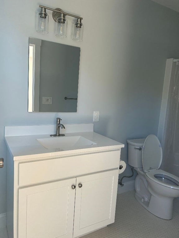29 Orange Street, Unit B Boston, MA 02131 - Photo 16 of 23 a bathroom with a toilet sink and mirror