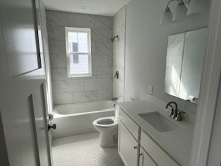 29 Orange Street, Unit B Boston, MA 02131 - Photo 18 of 23 a bathroom with a sink toilet and shower