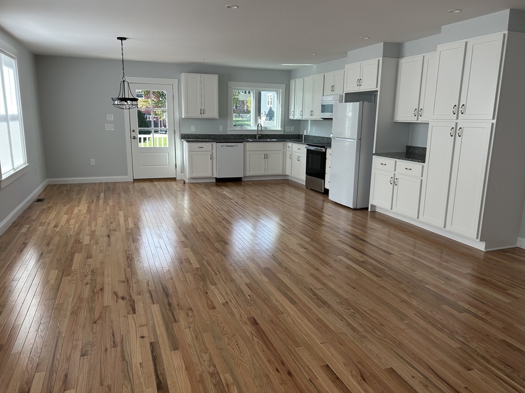 29 Orange Street, Unit B Boston, MA 02131 - Photo 3 of 23 a kitchen with a refrigerator and wooden floor