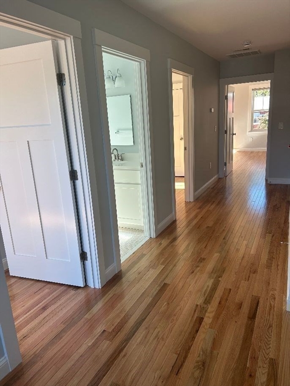 29 Orange Street, Unit B Boston, MA 02131 - Photo 9 of 23 a view of a hallway with wooden floor