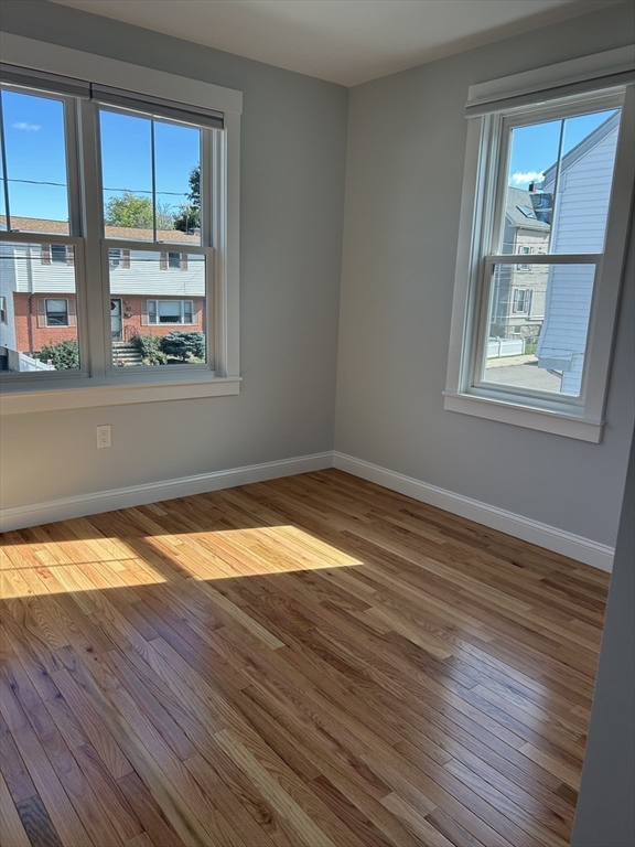 29 Orange Street, Unit B Boston, MA 02131 - Photo 10 of 23 a view of empty room with wooden floor and fan