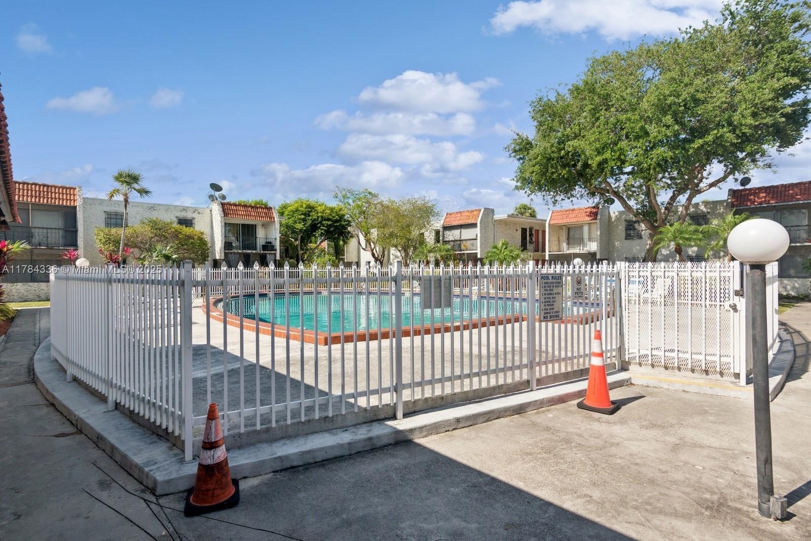 8701 Southwest 141st Street, Unit A5 Palmetto Bay, FL 33176 - Photo 12 of 19 a view of a porch with a bench