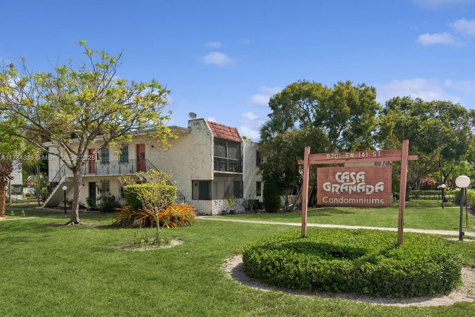 8701 Southwest 141st Street, Unit A5 Palmetto Bay, FL 33176 - Photo 17 of 19 a sign board with a house in the background
