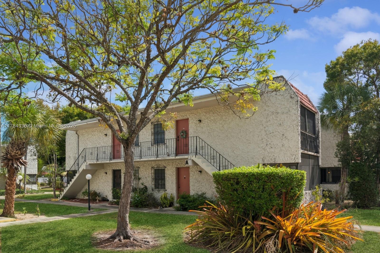 8701 Southwest 141st Street, Unit A5 Palmetto Bay, FL 33176 - Photo 18 of 19 front view of a house with a yard