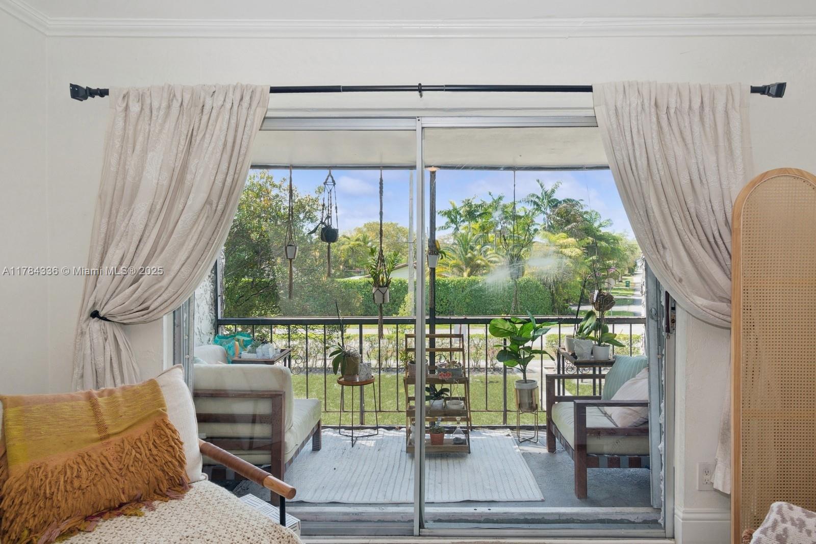 8701 Southwest 141st Street, Unit A5 Palmetto Bay, FL 33176 - Photo 2 of 19 a living room filled with furniture and a window
