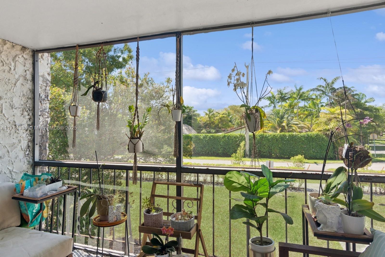 8701 Southwest 141st Street, Unit A5 Palmetto Bay, FL 33176 - Photo 4 of 19 a front view of a house with outdoor seating and plants