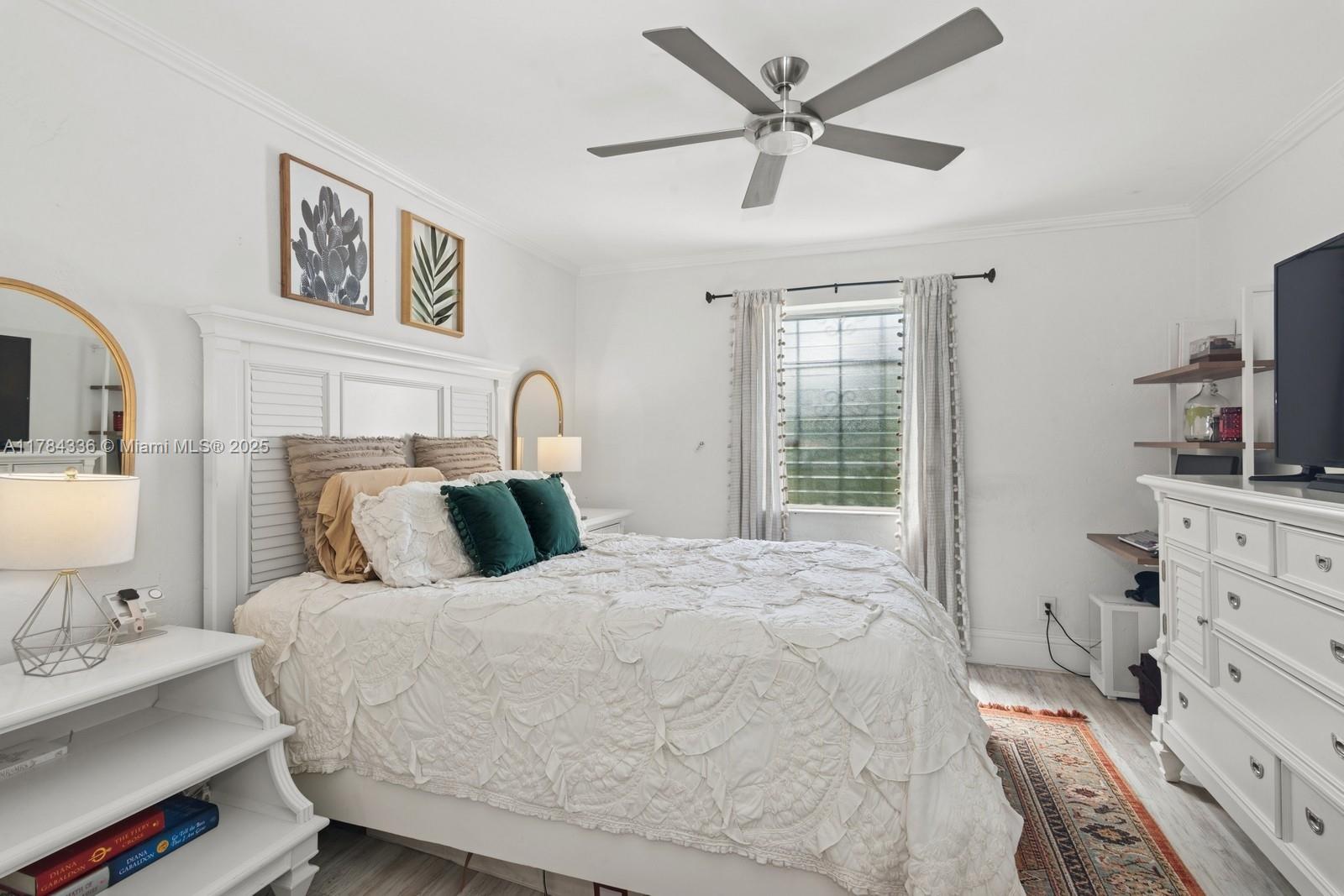 8701 Southwest 141st Street, Unit A5 Palmetto Bay, FL 33176 - Photo 8 of 19 a bedroom with a bed and wooden floor