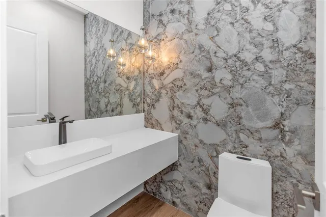 a bedroom with bed and painting on the wall