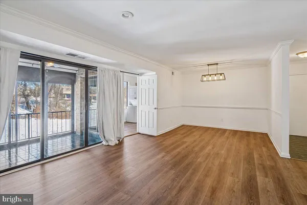 a view of a room with wooden floor