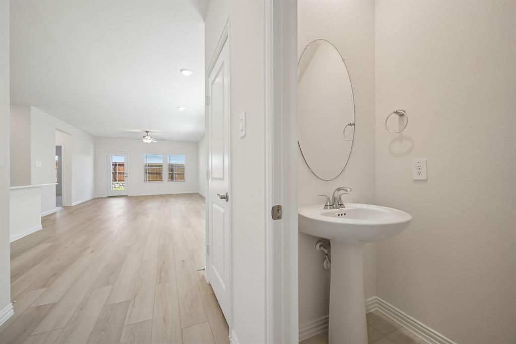 1705 Arches Road Anna, TX 75409 - Photo 18 of 33 a view of a sink and mirror with wooden floor