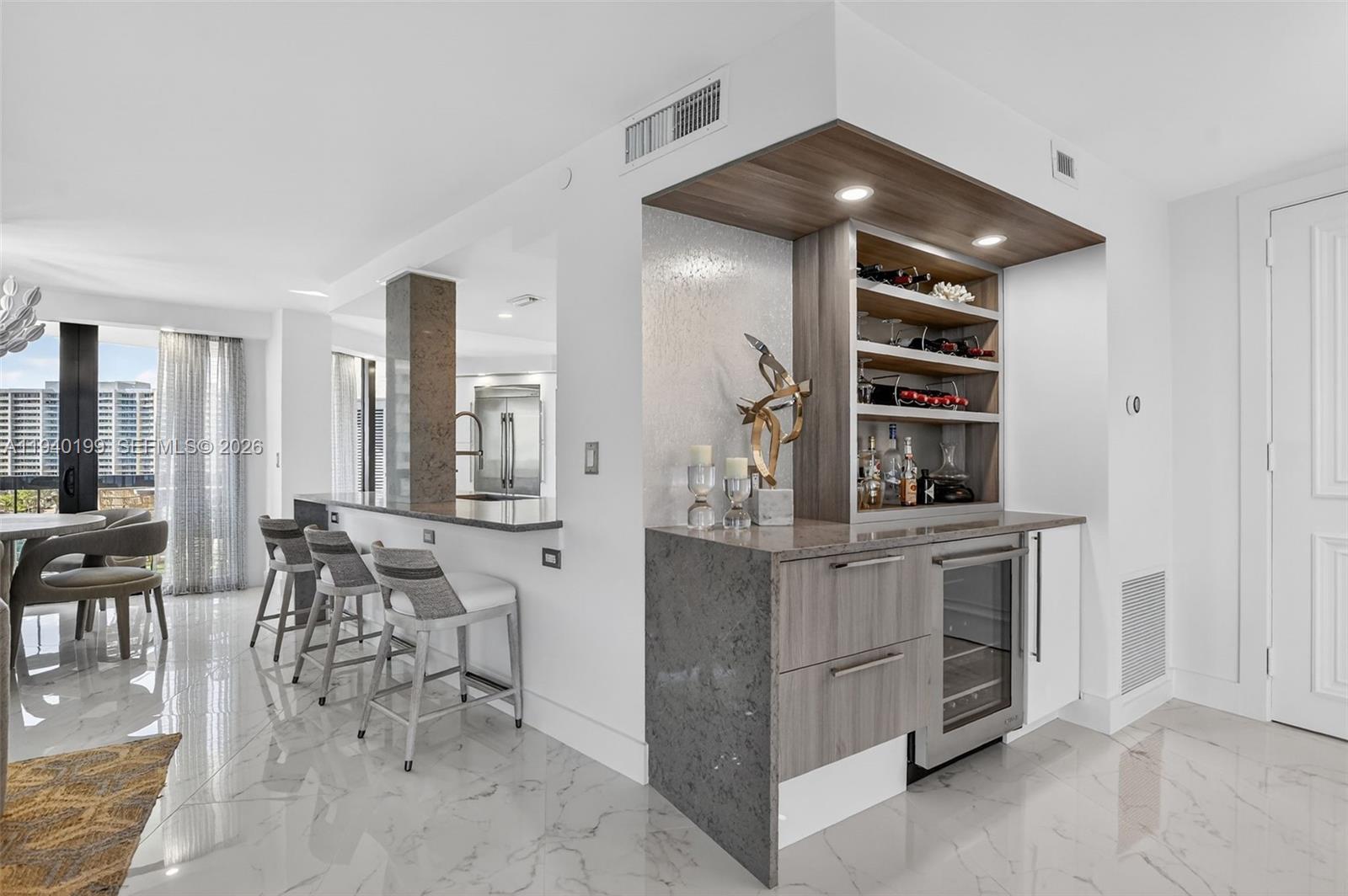 4545 North Ocean Boulevard, Unit 8B Boca Raton, FL 33431 - Photo 15 of 78 a kitchen with stainless steel appliances kitchen island granite countertop a table and chairs in it