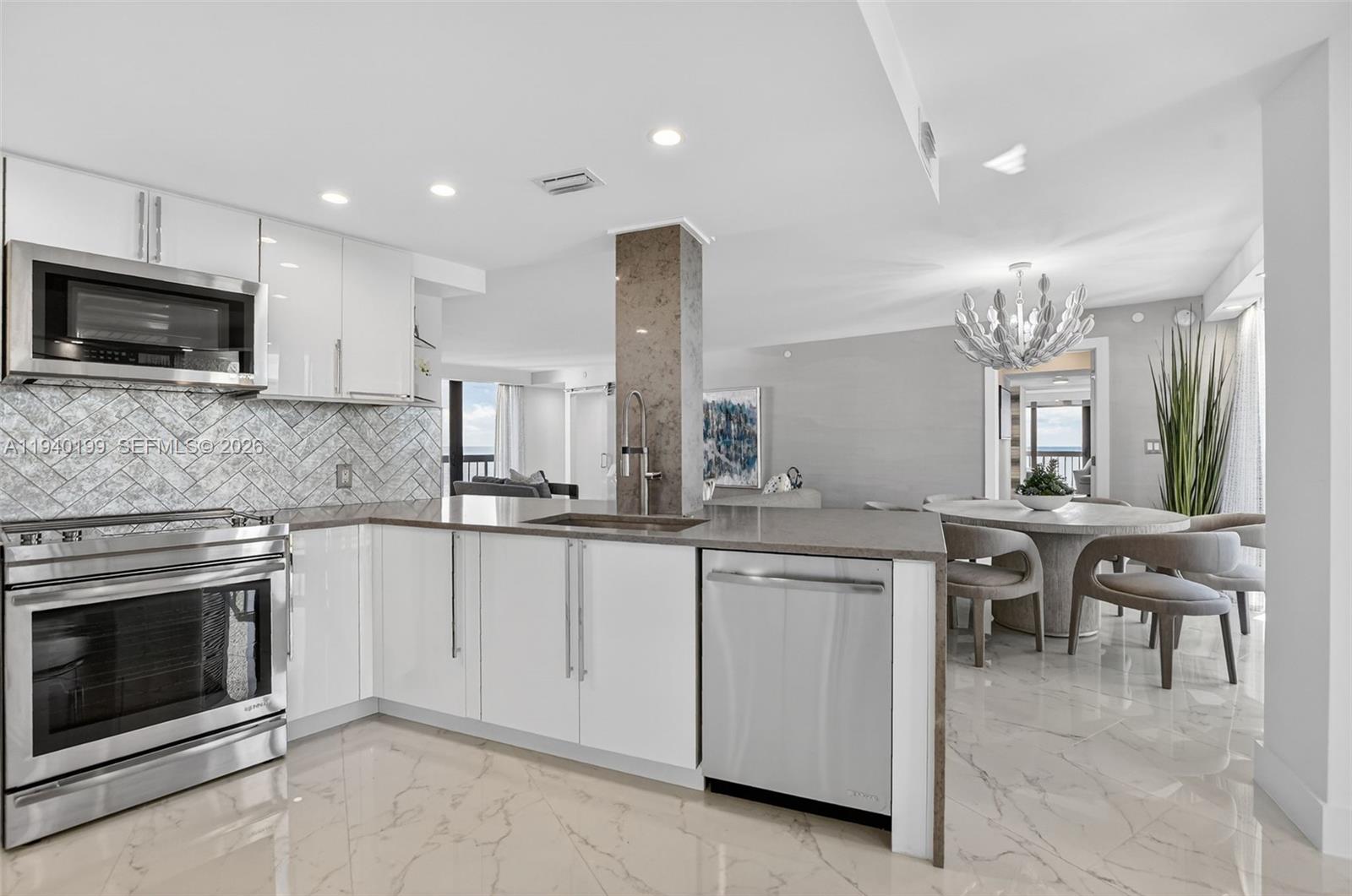 4545 North Ocean Boulevard, Unit 8B Boca Raton, FL 33431 - Photo 17 of 78 a kitchen with cabinets a sink and appliances