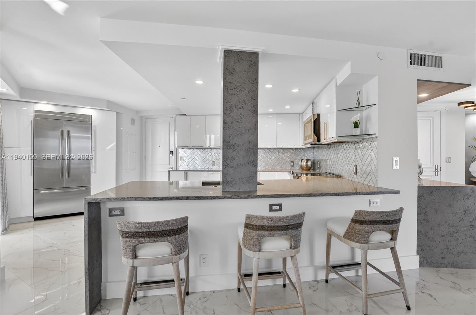 4545 North Ocean Boulevard, Unit 8B Boca Raton, FL 33431 - Photo 20 of 78 a kitchen with granite countertop a sink and chairs
