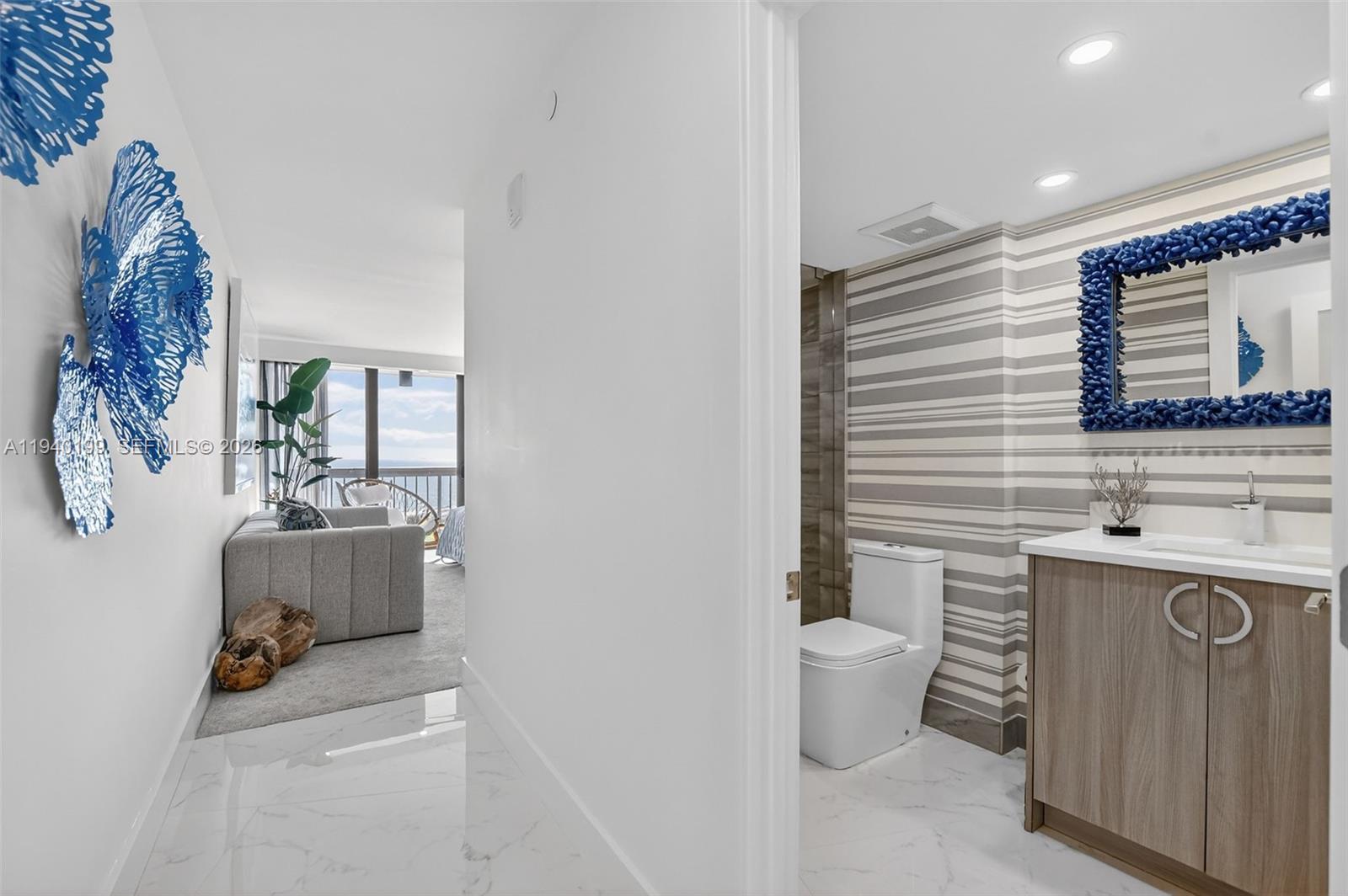 4545 North Ocean Boulevard, Unit 8B Boca Raton, FL 33431 - Photo 47 of 78 a bathroom with a sink toilet and mirror