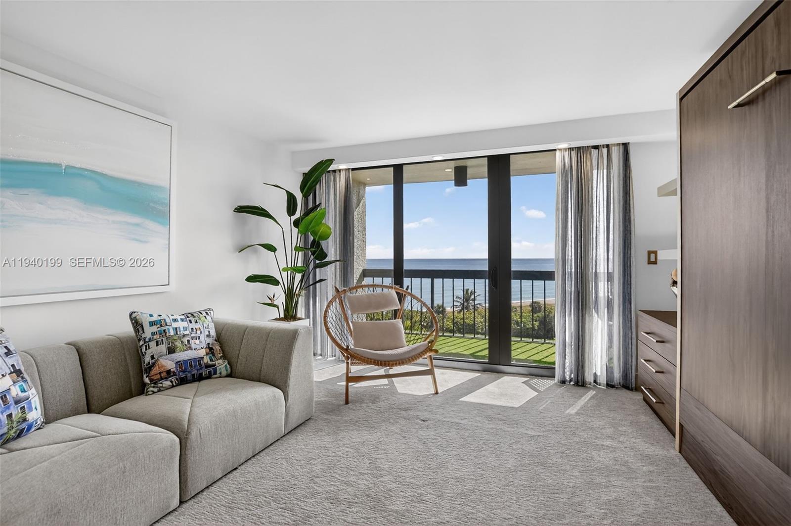 4545 North Ocean Boulevard, Unit 8B Boca Raton, FL 33431 - Photo 48 of 78 a living room with furniture and a floor to ceiling window