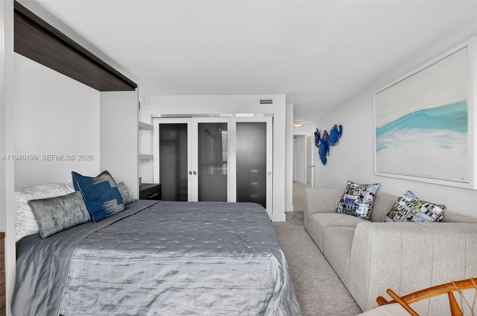 4545 North Ocean Boulevard, Unit 8B Boca Raton, FL 33431 - Photo 50 of 78 a bedroom with a large bed and a couch