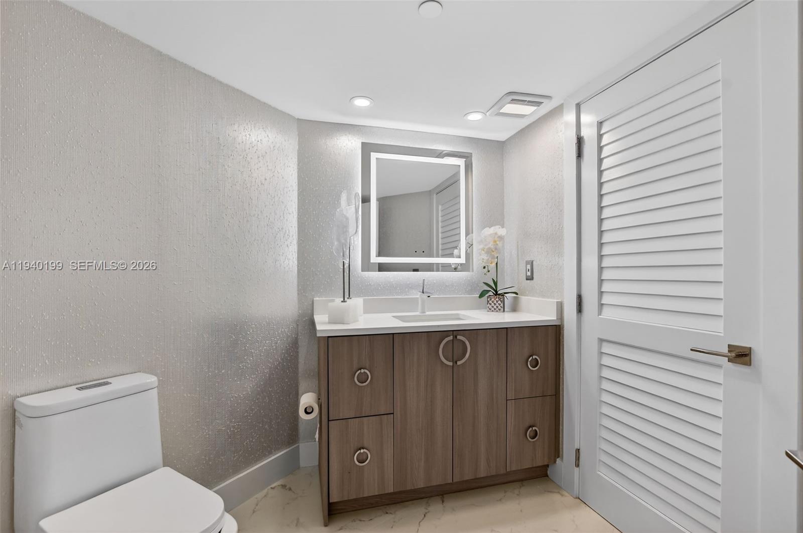 4545 North Ocean Boulevard, Unit 8B Boca Raton, FL 33431 - Photo 58 of 78 a bathroom with a toilet a sink a mirror and a shower