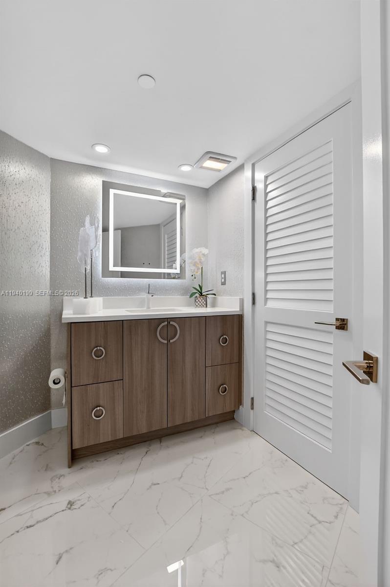 4545 North Ocean Boulevard, Unit 8B Boca Raton, FL 33431 - Photo 59 of 78 a bathroom with a granite countertop sink a mirror and a