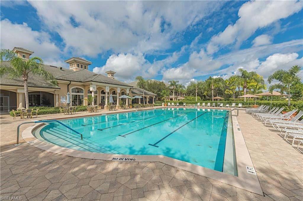 6017 Trophy Drive, Unit 601 Naples, FL 34110 - Photo 15 of 24 a view of swimming pool in front of residential houses