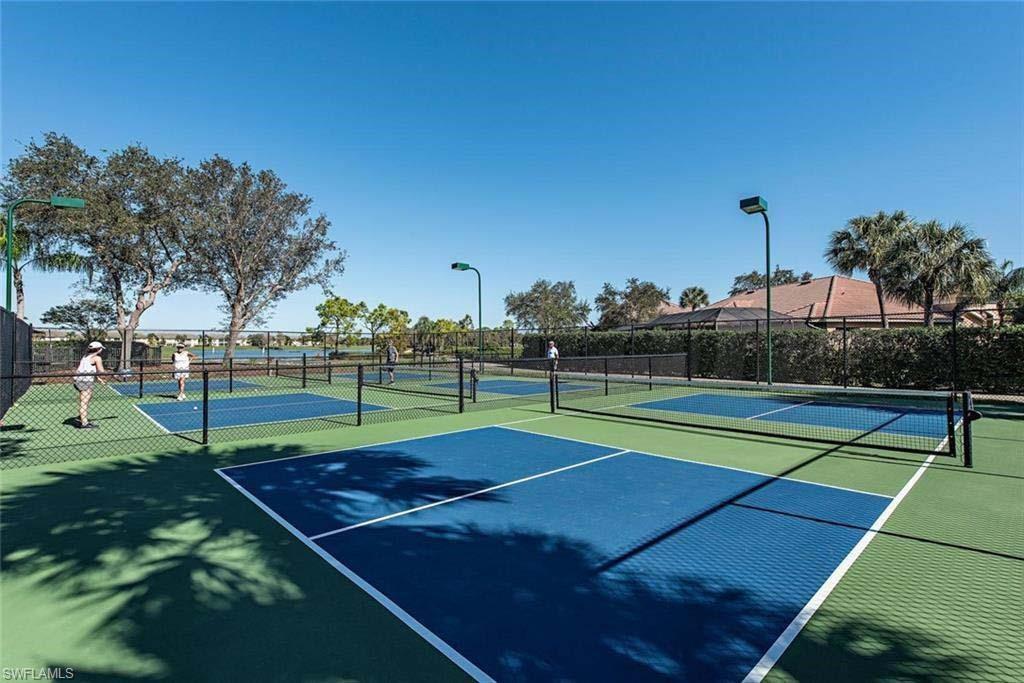 6017 Trophy Drive, Unit 601 Naples, FL 34110 - Photo 16 of 24 a tennis court that has tennis net