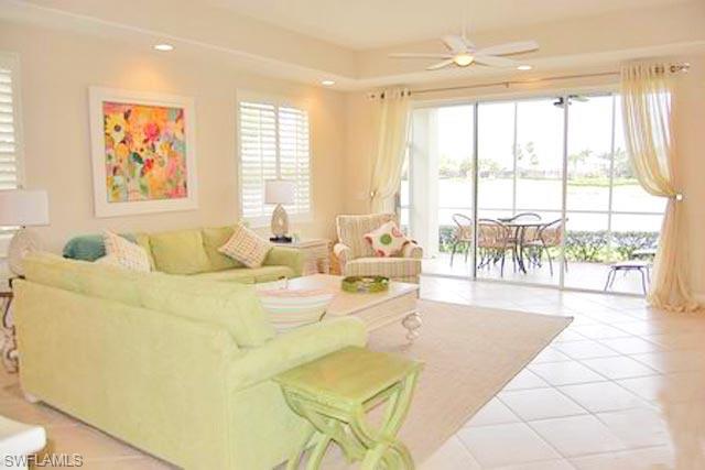 6017 Trophy Drive, Unit 601 Naples, FL 34110 - Photo 2 of 24 a living room with furniture and large windows