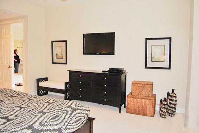 6017 Trophy Drive, Unit 601 Naples, FL 34110 - Photo 7 of 24 a bedroom with a bed and a flat screen tv