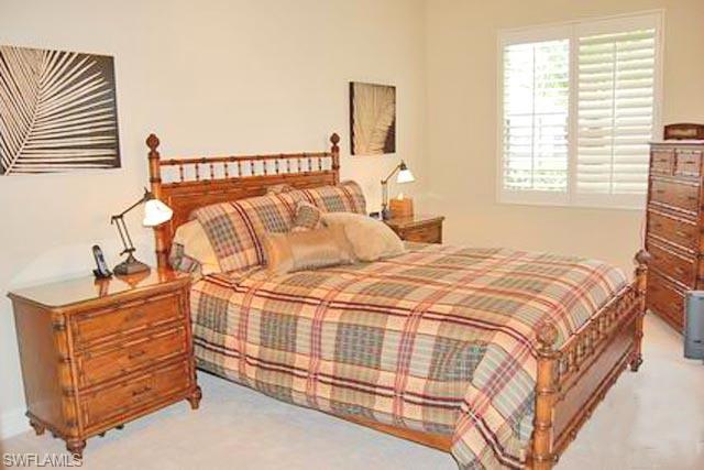 6017 Trophy Drive, Unit 601 Naples, FL 34110 - Photo 9 of 24 a bedroom with a bed and a window
