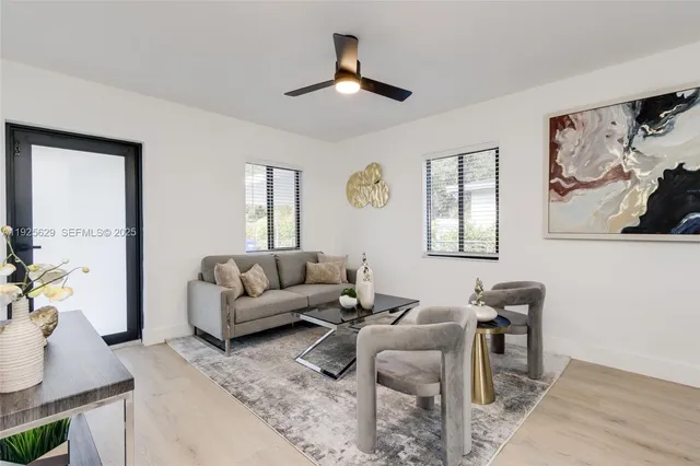 a living room with furniture a rug and a window