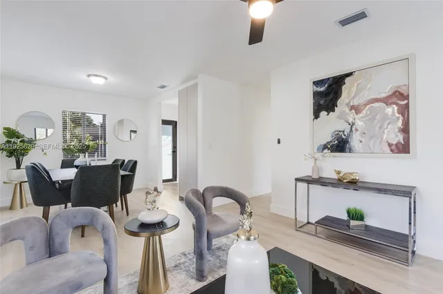 a dining room with furniture and wooden floor