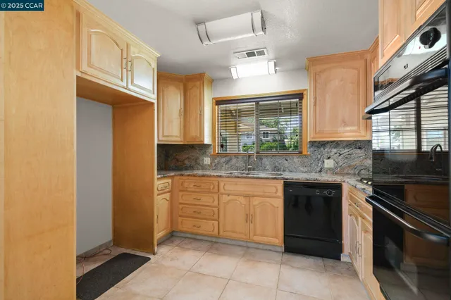 a view of a room with a ceiling fan and window