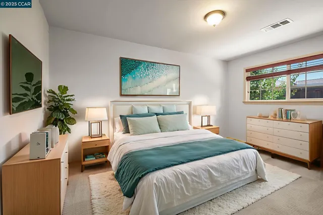 a bedroom with a large bed and a couch