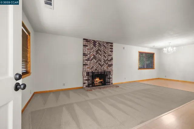 a view of a room with a window and wooden floor