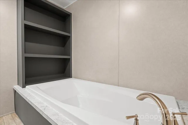 a bathroom with a double vanity sink a mirror and a toilet